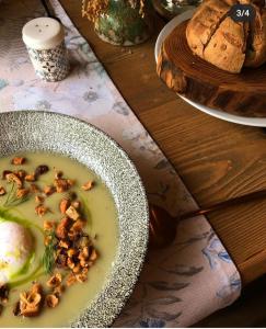 a bowl of soup with nuts on a wooden table at Agriturismo Borghetto la radice in Roccaverano
