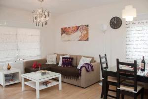 a living room with a couch and a table at Apartamento Kalma by Vacanzy Collection in Corralejo