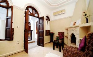 - un salon avec un canapé et une cheminée dans l'établissement Riad Elias & Spa, à Marrakech