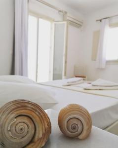 two wooden logs sitting on a table in a room at Aegeo Inn Apartments in Antiparos Town