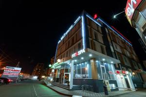 a building on a city street at night at Hotel "VITAMIN" in Krasnodar