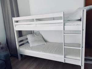 a white bunk bed with a pillow on it at GM Studio in La Grande-Motte