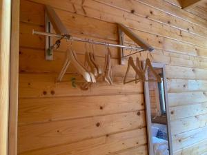 a wooden wall with a rack of utensils at Immaculate Cabin 5 mins to Inverness Dog friendly in Inverness