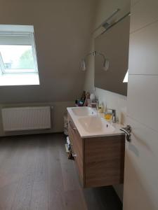 a bathroom with a sink and a mirror at Logement douillet neuf L'INDIAN in Dossenheim-sur-Zinsel
