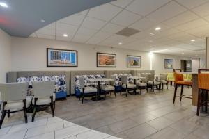 a dining room with tables and chairs in a room at Alexis Inn and Suites Hotel in Nashville