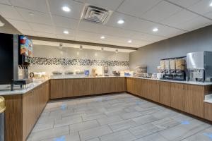a restaurant with a large kitchen with blue drawings on the floor at Alexis Inn and Suites Hotel in Nashville