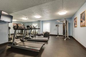 a gym with several tread machines in a room at Alexis Inn and Suites Hotel in Nashville