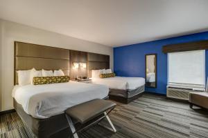 a hotel room with two beds and a window at Alexis Inn and Suites Hotel in Nashville