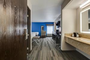 a corridor of a hotel room with a bathroom at Alexis Inn and Suites Hotel in Nashville