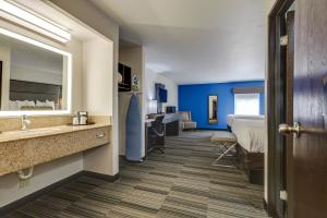 a hotel room with a bed and a bathroom at Alexis Inn and Suites Hotel in Nashville +37 photos