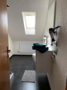 a bathroom with a toilet and a window at Casa Blanca 3 in Ottenheim