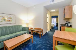 a hotel room with a couch and a table at Holiday Inn Express Ashland, an IHG Hotel in Ashland