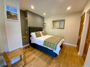 A bed or beds in a room at Arfryn House Bed and Breakfast