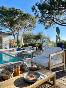 a table with food on it next to a pool at Les Suites d'Agosta in Porticcio