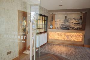 a room with a counter and a window in a room at The Redhurst Hotel Glasgow in Giffnock