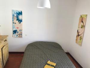 ein Schlafzimmer mit einem Bett und zwei Bildern an der Wand in der Unterkunft Mirabel in La Cadière-dʼAzur