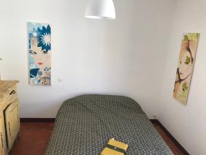 a bedroom with a bed and two pictures on the wall at Mirabel in La Cadière-dʼAzur