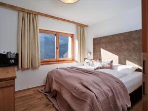Ένα ή περισσότερα κρεβάτια σε δωμάτιο στο Boutique Apartment Sonnenhang - incl InfinityPOOL