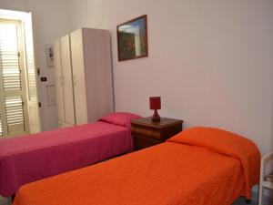 Ένα ή περισσότερα κρεβάτια σε δωμάτιο στο Casavacanza vicino la spiaggia Ll71