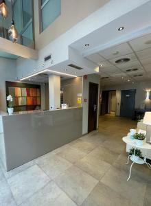 an office lobby with a reception counter and tables at SM Hotel Sant Antoni in Barcelona