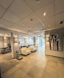 a lobby with couches and a painting on the wall at SM Hotel Sant Antoni in Barcelona