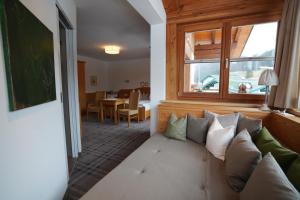 a living room with a couch and a window at Landhaus Filzmoos in Filzmoos