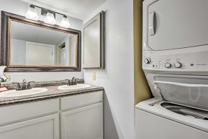 a bathroom with two sinks and a washing machine at Cozy Cabin with Sunroom and Cacapon River Access! in Capon Bridge +20 photos