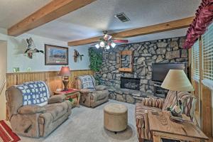 a living room with a stone wall at Secluded Edgemont Getaway with Huge Outdoor Deck! in Fairfield Bay