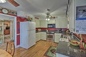 a kitchen with white appliances and a white refrigerator at Secluded Edgemont Getaway with Huge Outdoor Deck! in Fairfield Bay