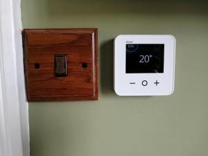 a switch on a wall with a lightswitch on it at North Ings in Robin Hood's Bay