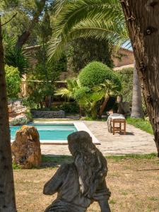 
a wooden bench sitting next to a palm tree at Agroturismo Son Fogueró - Adults Only in Maria de la Salut
