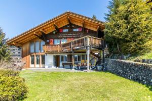 a large wooden house with a large balcony at Chalet Steingärtli 1 in Wengen
