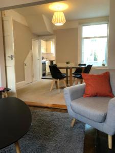 a living room with a couch and a table at Radford Place - Central Exeter - Patio & Garden - Beach - Chiefs - Uni -WiFi in Exeter