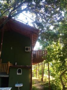 a tree house with a deck on the side of it at Fire Pansiyon in Cıralı