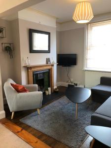 a living room with a couch and a fireplace at Radford Place - Central Exeter - Patio & Garden - Beach - Chiefs - Uni -WiFi in Exeter