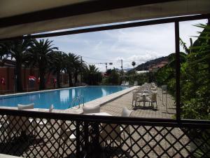 a view of a swimming pool from a balcony at Bike and Breakfast Apartments in Pietra Ligure