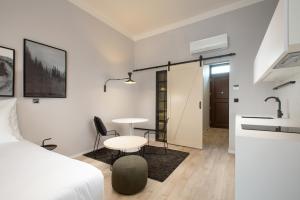 a bedroom with a bed and a table and a sink at OREA Place Seno in Prague