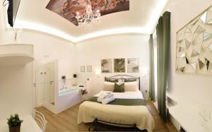 a bedroom with a bed and a chandelier at Vittorio Veneto Private SPA in Sulmona