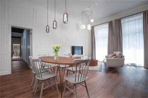 a dining room and living room with a table and chairs at OREA Place Seno in Prague