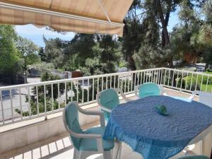 a blue table and chairs on a balcony at Palio Villa in Paleo Tsifliki