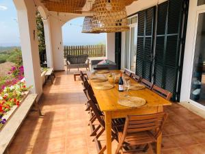 a wooden table and chairs on a patio at BINIALMESC in Alaior