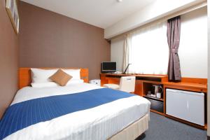a hotel room with a large bed and a television at HOTEL MYSTAYS Nagoya Sakae in Nagoya