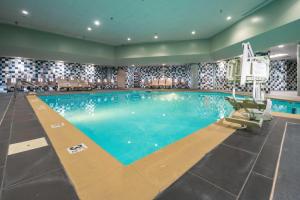 a large swimming pool with blue water at Holiday Inn Louisville East - Hurstbourne by IHG in Louisville