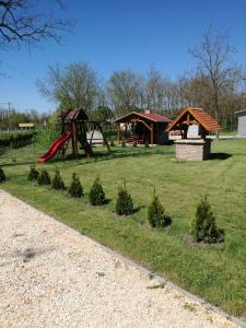 a park with a playground and a play structure at Kaptárlevegős Vendégház in Füzesgyarmat