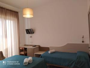 Postel nebo postele na pokoji v ubytování Hotel Maria