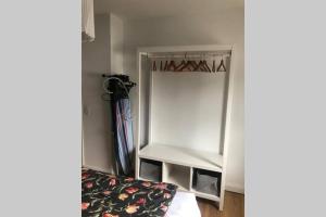 a small white refrigerator in a room at 5-Zi. Wohnung in Bahnhofsnähe - 24/7 self-check-in in Borstel +2 photos