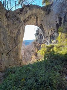 an arch in the side of a rocky mountain at Hotel Ristorante Montenerone in Apecchio