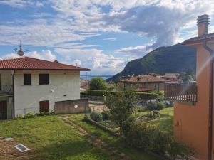 a view of a village with a mountain in the background at Casa Pina in Tignale