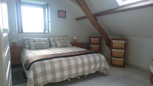 a bedroom with a bed and a window at La Joie du Muguet Detached cottage Private heated swimming pool Shared Games room in Auverse