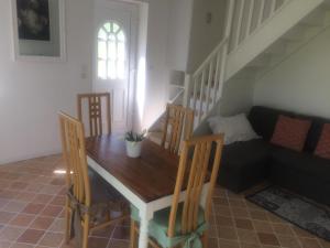 a dining room with a table and chairs and a couch at Maison de Vacances Cronat - Au Bord de l'EuroVelo 6 in Cronat